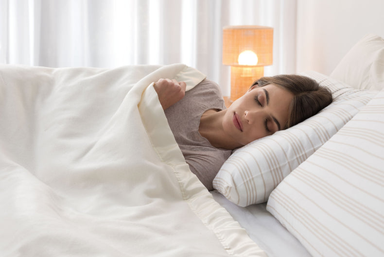 Woman covered with Peaceful Dreams Dual Control Overblanket