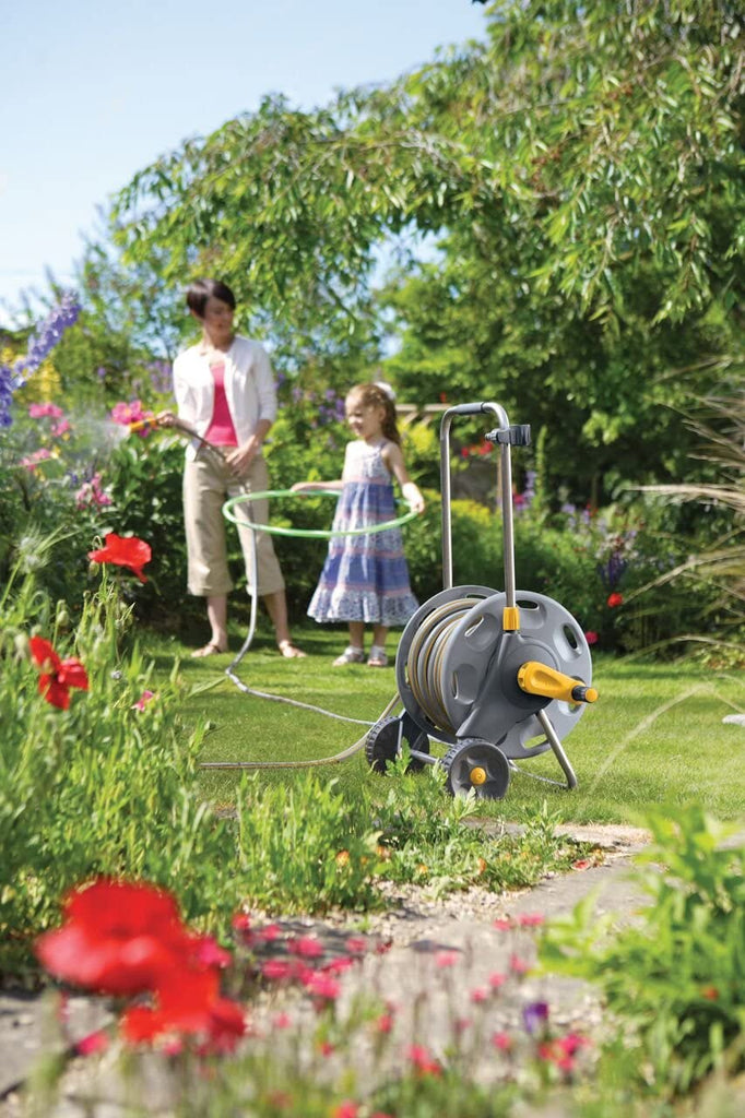 Hose Reel Cart 2434 30m Hose shown in a garden with a mother using the hose and her daughter playing with a hula hoop