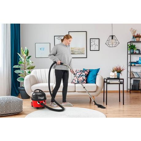 Woman Vacuuming with Henry Vacuum Cleaner