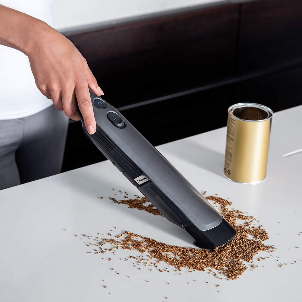 Woman cleaning counter with Hand Held Vacuum