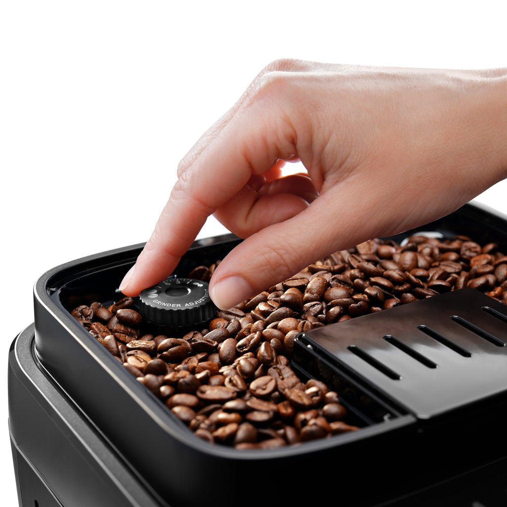 Hand touching coffee beans tray