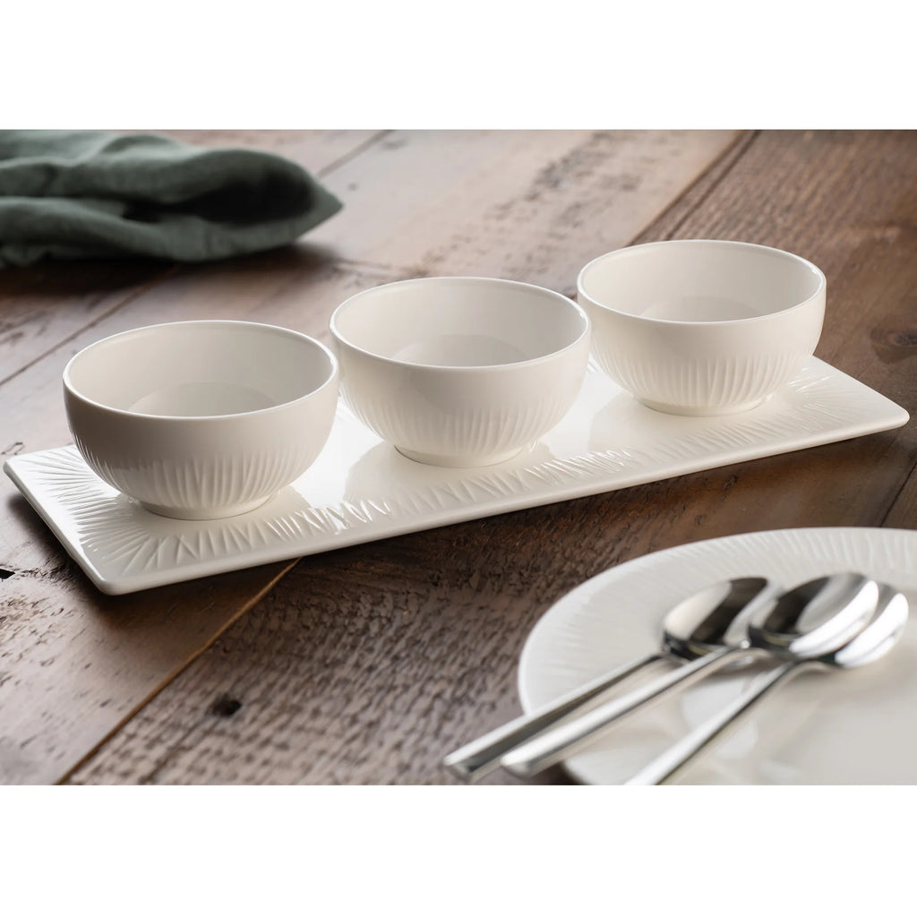 Belleek 9315 Erne Triple Bowl Set - small Erne triple bowl set pictured on a wooden table set beside an Erne plate with cutlery