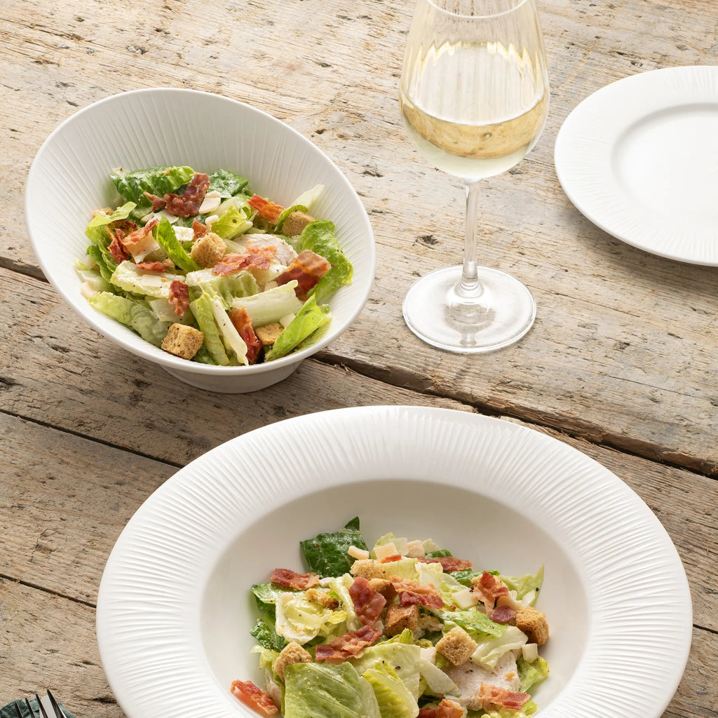 Belleek 9318 Erne Serving Bowl - Erne serving bowl holding a salad inside, set on top of a table pictured with other Erne dishes served with food