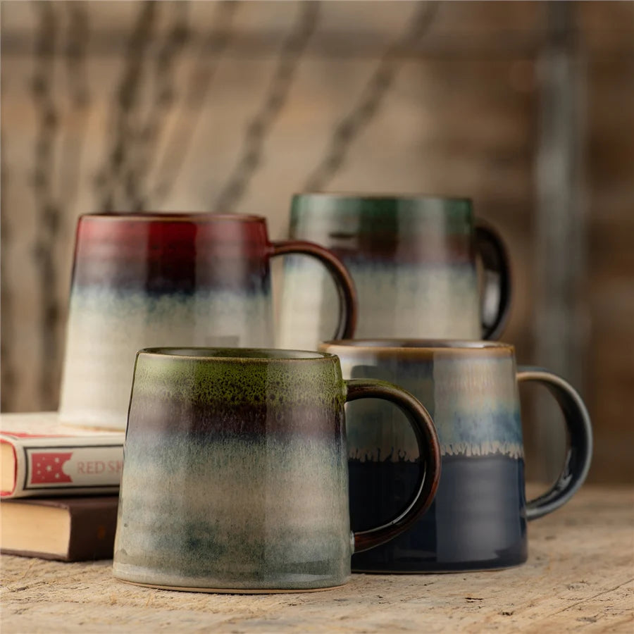 Belleek 9418 Aura Mug - Set of 4 - 4 Aura mugs on a wooden table with two of them placed on top of a stack of books