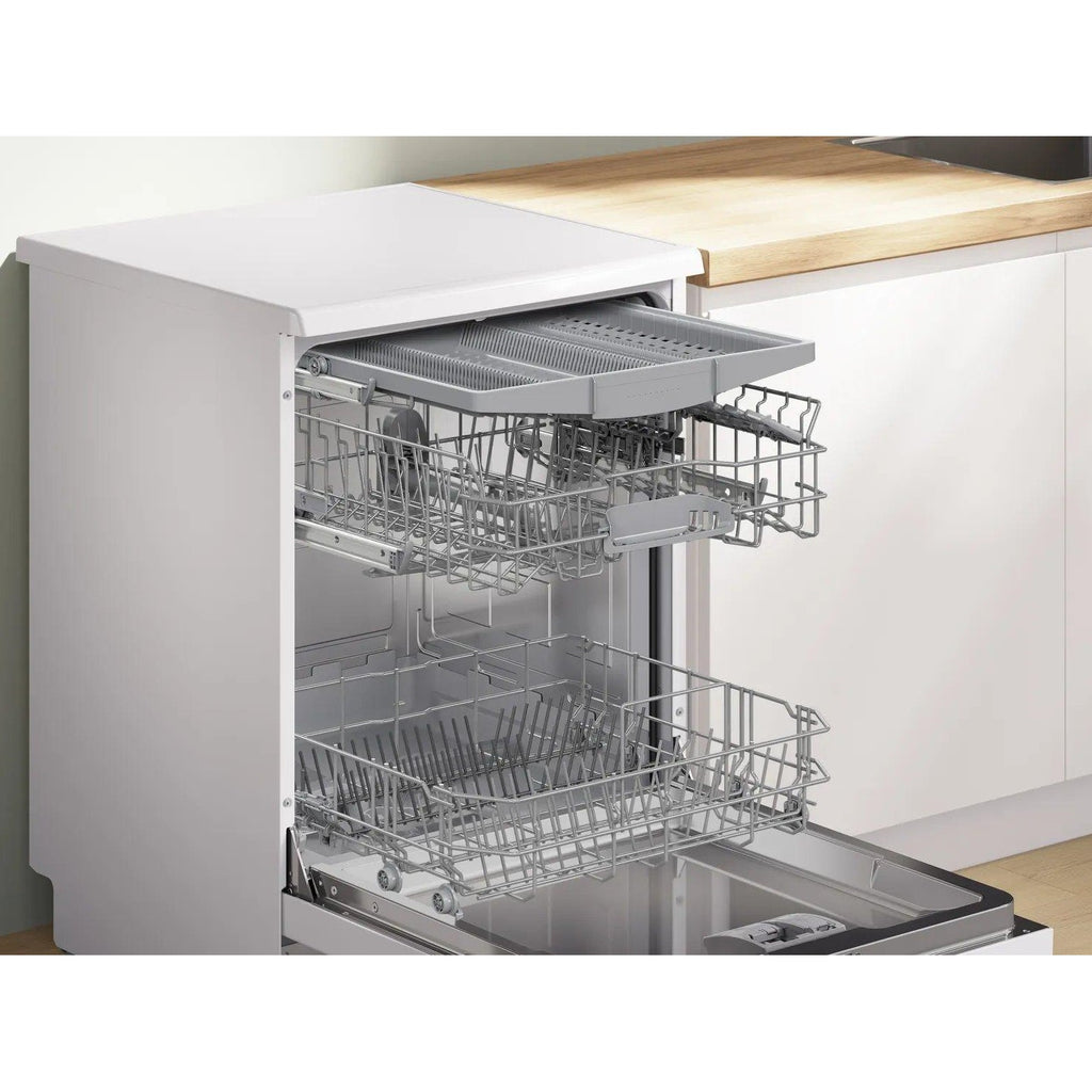 Bosch SMS2HVW67G Dishwasher - front of Bosch dishwasher pictured at an angle in a kitchen interior with the dishwasher door open and racks extended out