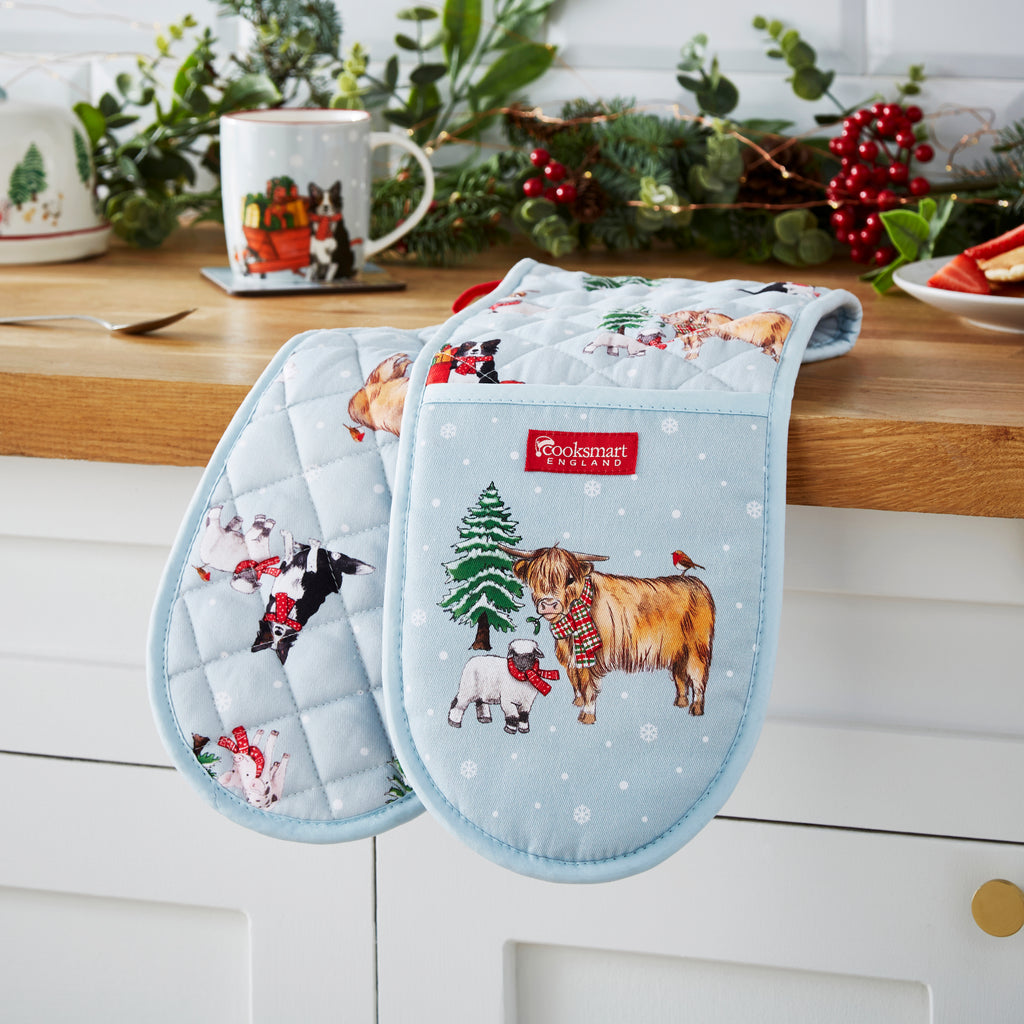 Cooksmart Christmas On The Farm Double Oven Glove opened on a wooden counter top