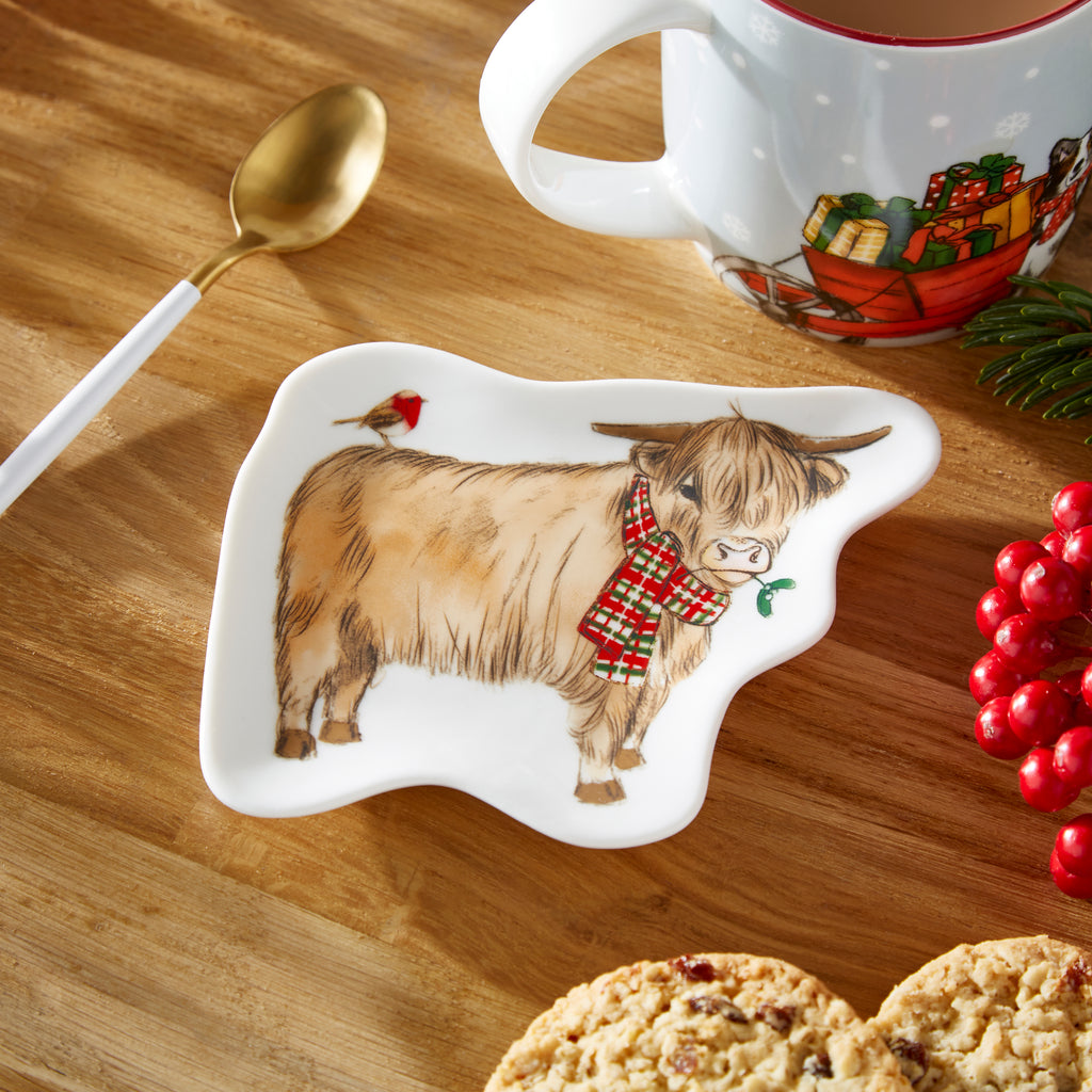 Cooksmart Christmas On The Farm Ceramic Tea Bag Tidy sitting on a wooden table