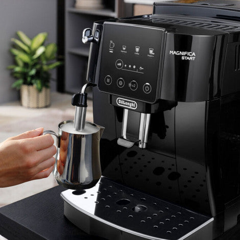 Delonghi ECAM220.22GB coffee maker in lifestyle image frothing milk in a s/s jug