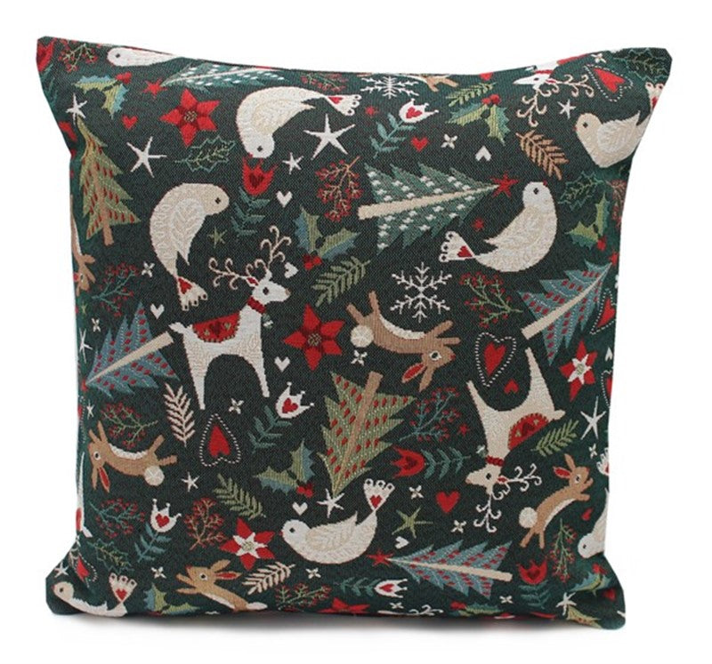 Green cushion with deers, rabbits, birds and Christmas trees on it