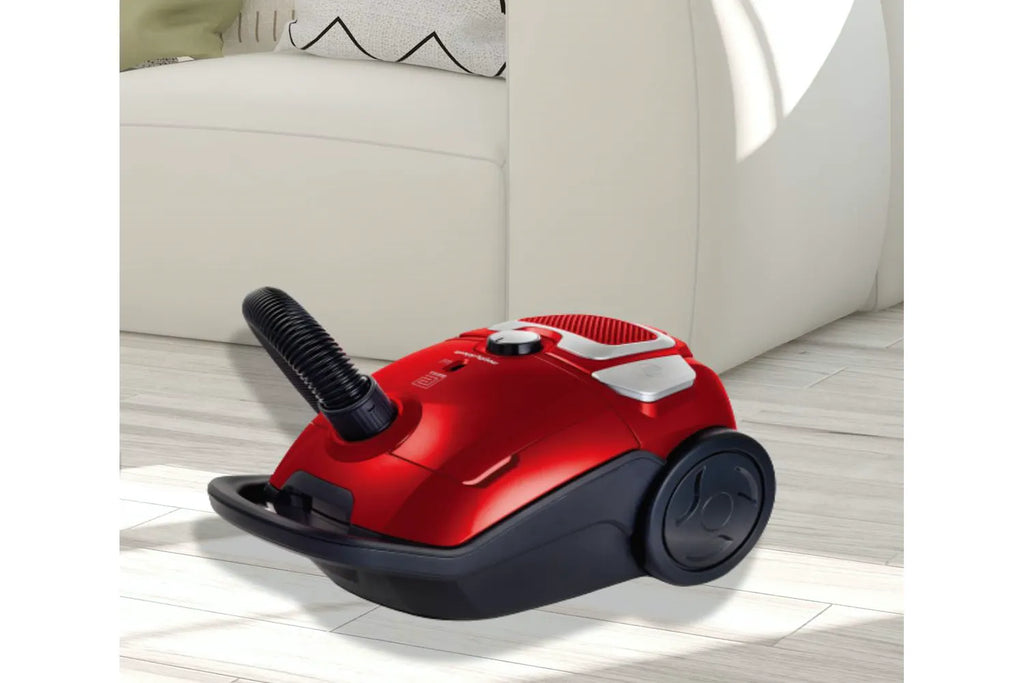 Morphy Richard 980565 Bagged Compact Cylinder Vacuum Cleaner - view of vacuum cleaner from the side at an angle pictured in a living room