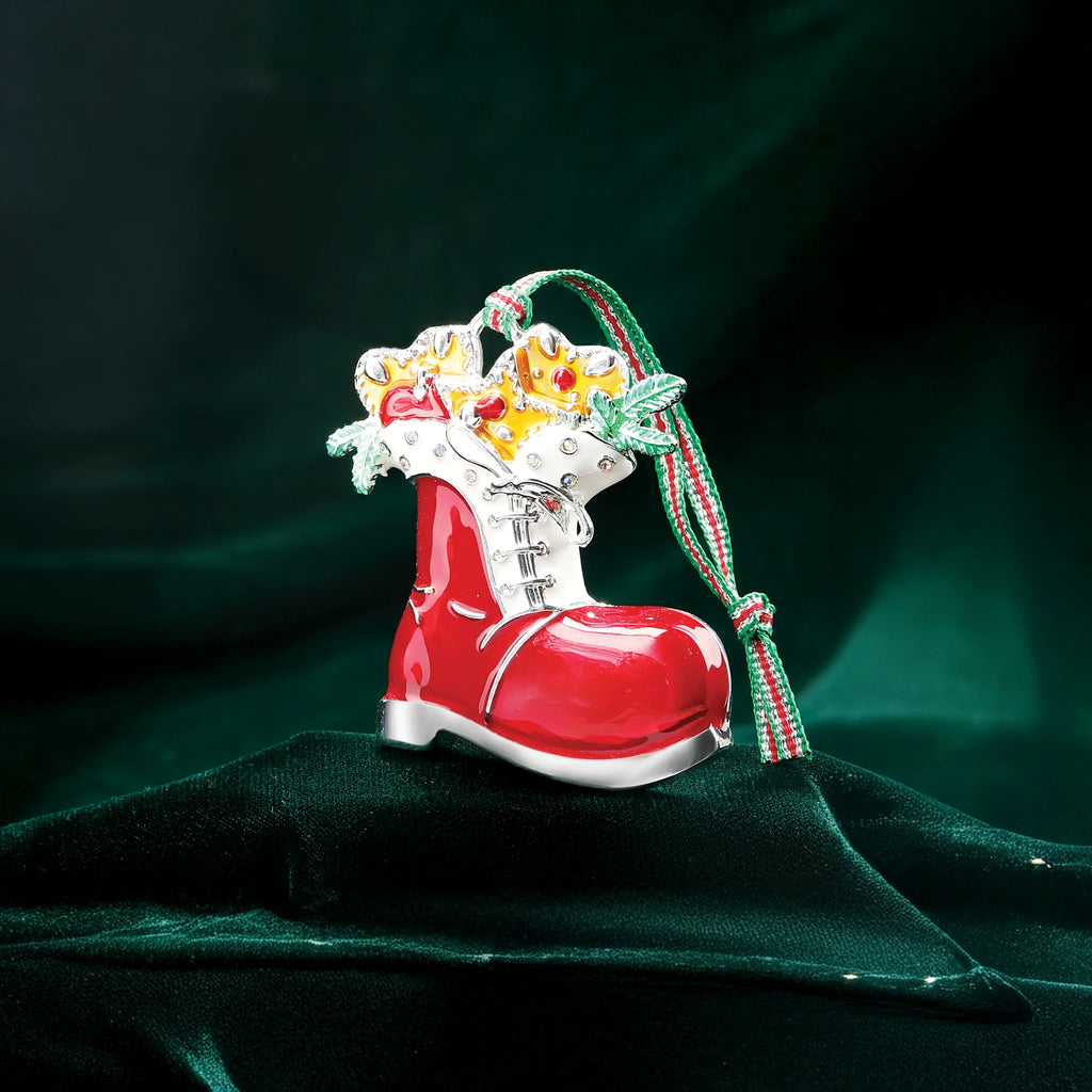 Red boot ornament with decorative elements on a dark green background