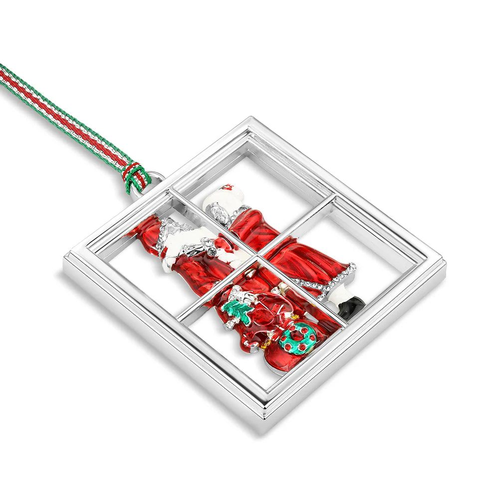 Christmas-themed ornament with Santa Claus and reindeer in a window display on a white background.
