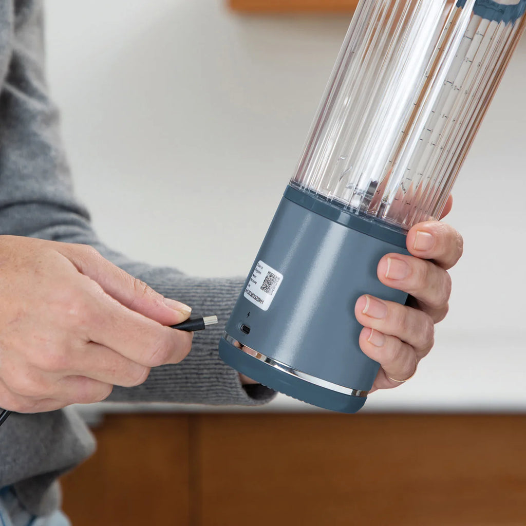 Ninja BC151UKNV Blast Blender In Denim Blue - close-up of person plugging in a USB-C charger to the blender