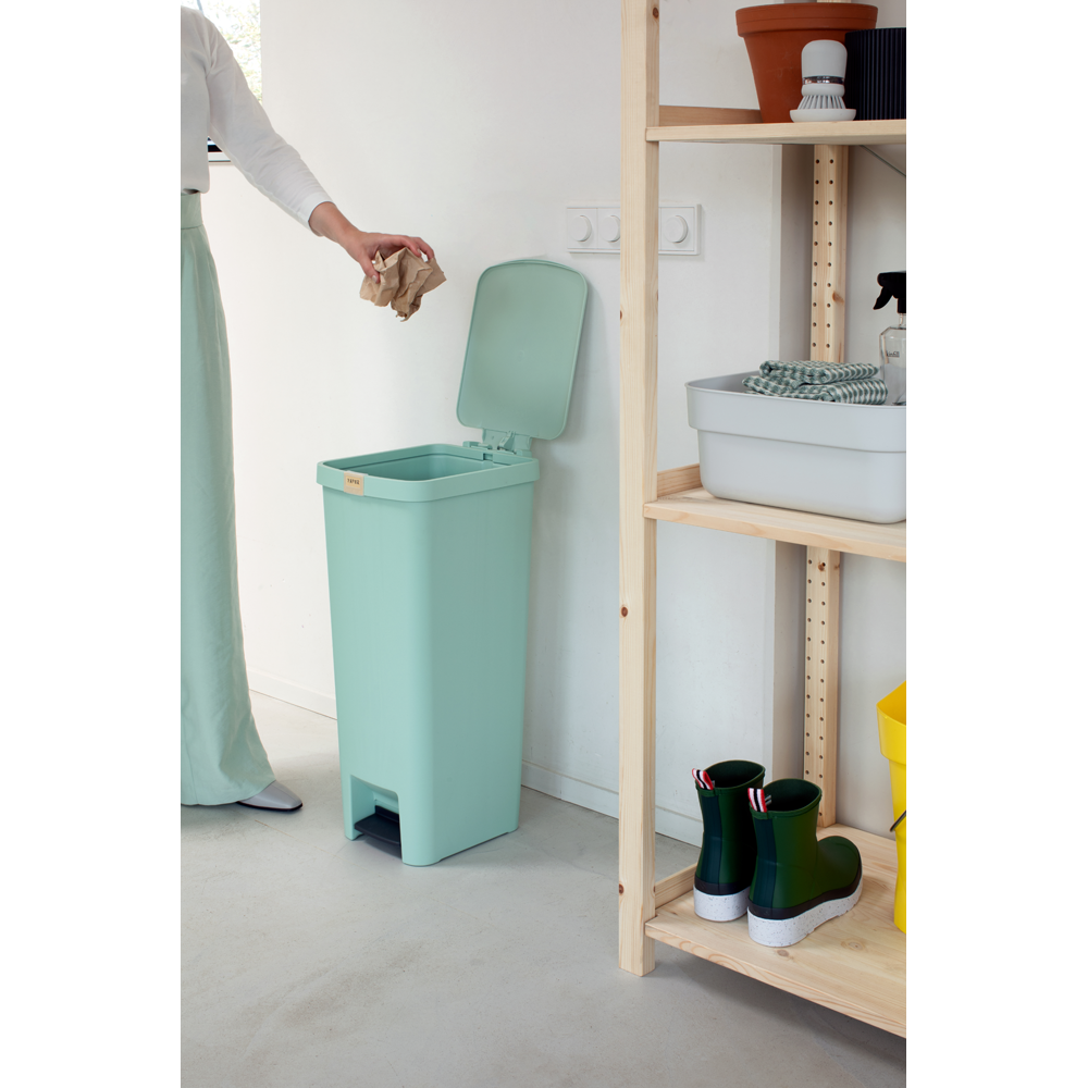 Person putting rubbish inside Jade Green bin