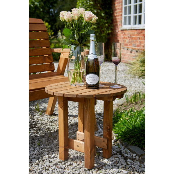 Tom Chambers GP093 Richmond Coffee Table with a plant, wine bottle & glasses sitting on it.