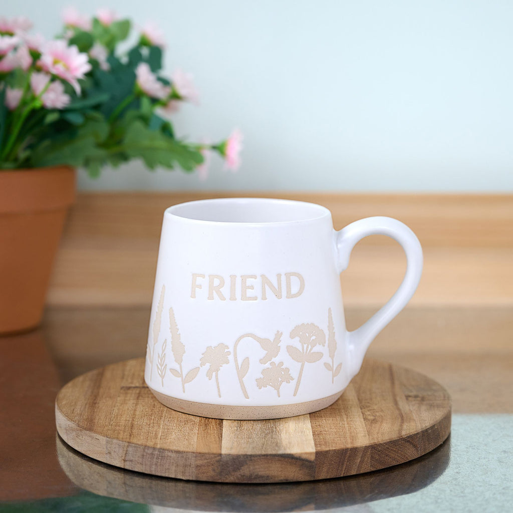 TC168F The Cottage Garden Mug White Floral "Friend" - mug placed on a coaster on top of a table