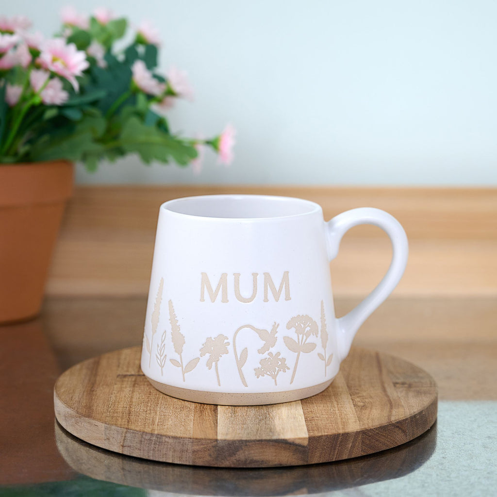 TC168M The Cottage Garden Floral Mug White "Mum" - mug on a coaster set on top of a table