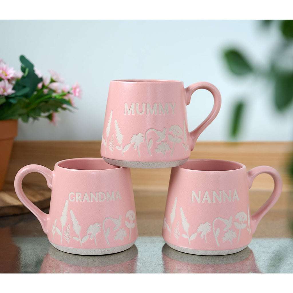 TC169GM The Cottage Garden Floral Mug Pink " Grandma" - 3 different designs for the same mug set on top of each other on a table