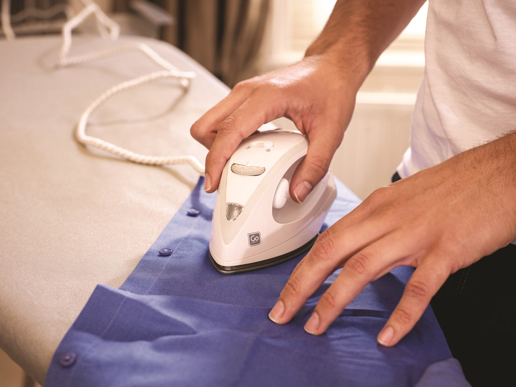Man ironing shirt with Ultra Compact Steam iron