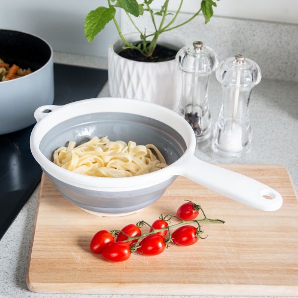 Colander with pasta and cherry tomatoes