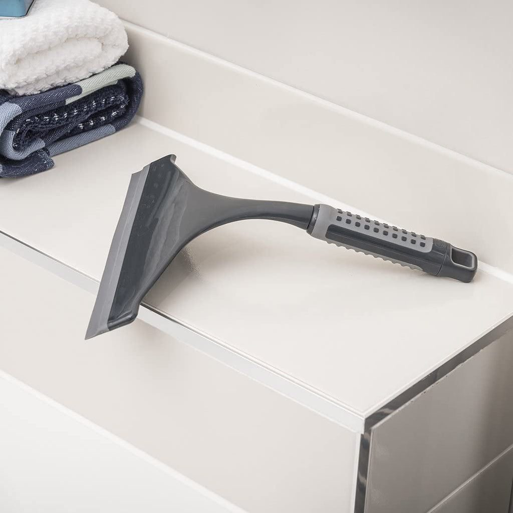 Addis 517699 Comfi Grip Shower Squeegee, Graphite sitting on the tiles in the bathroom
