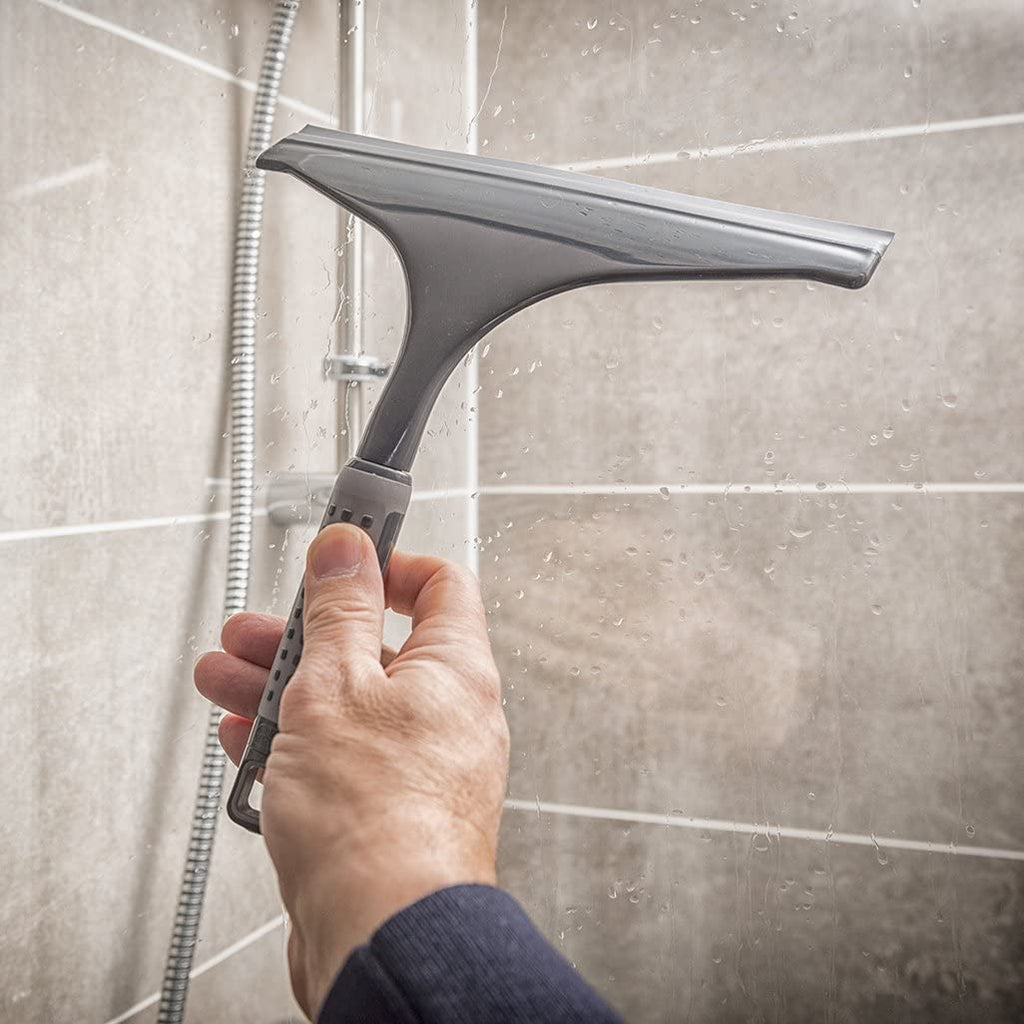 Addis 517699 Comfi Grip Shower Squeegee, Graphite showing someone using it in the shower