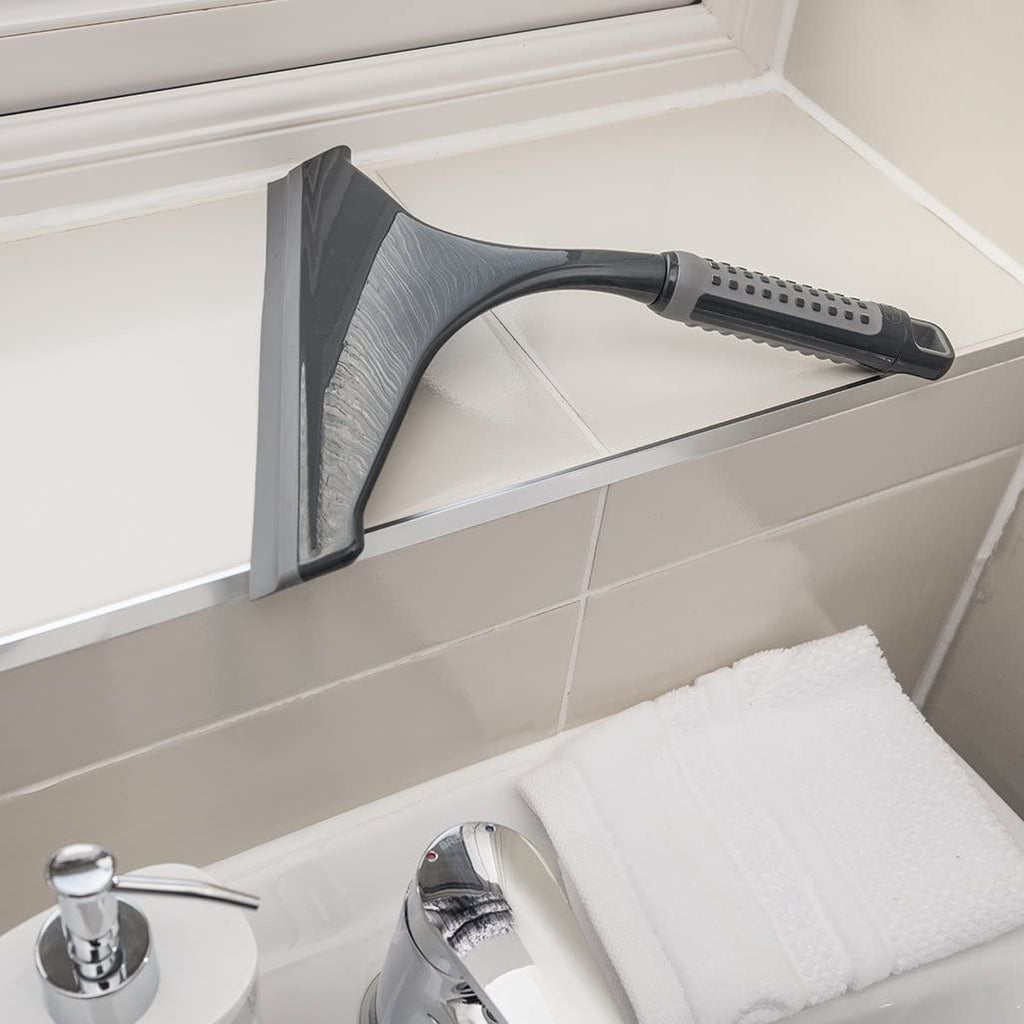 Addis 517699 Comfi Grip Shower Squeegee, Graphite sitting on the window sill