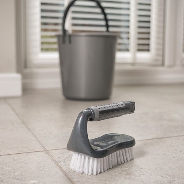  showing the brush on the floor near a bucket