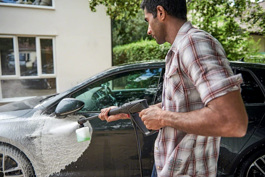 Man washing car with pressure Washer Aquatak