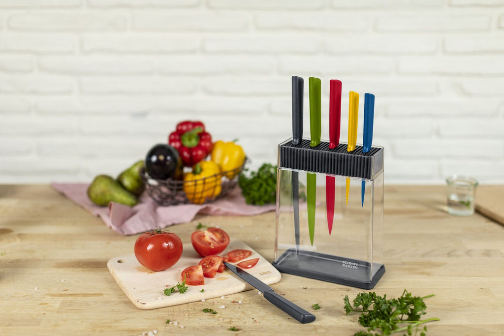 Kuhn Rikon 24263 7pc Colori Knife Set sitting on the countertop while one nife is being used