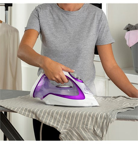 Woman ironing with Turbo Glide Iron White & Purple