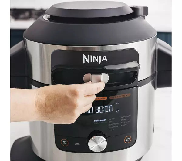 Person moving button on Ninja Multi-Cooker & Pressure Cooker