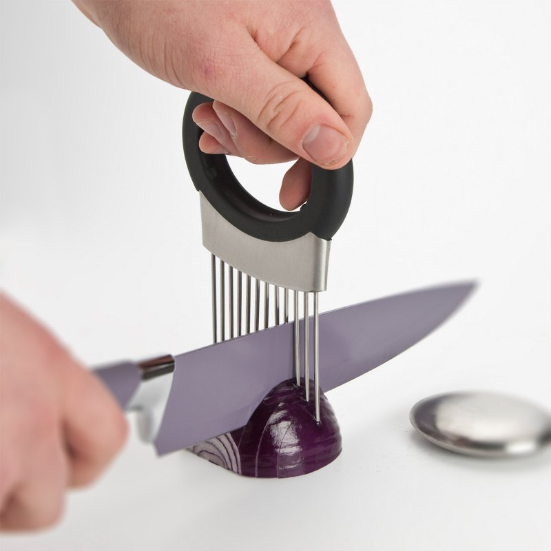 Person cutting onion with vegetable holder