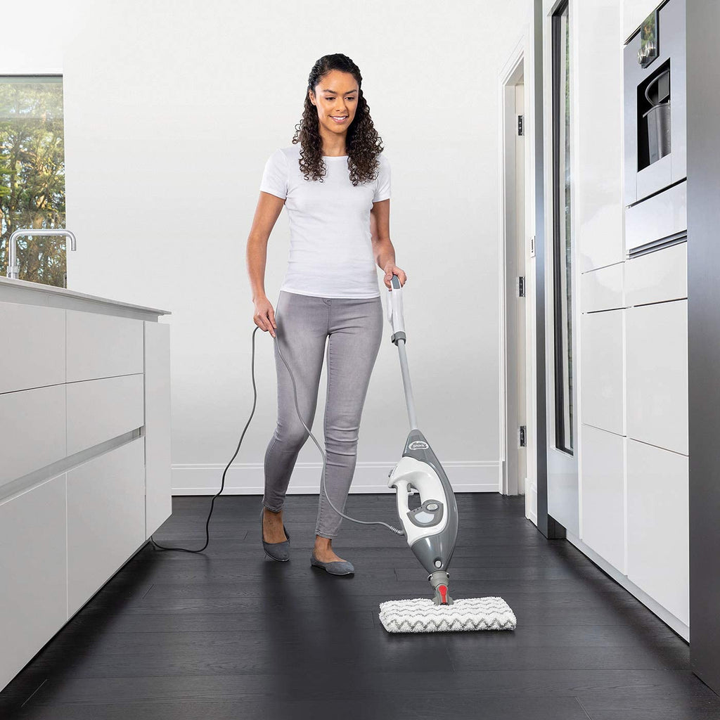 Woman cleaning floor with Floor and Handheld Steam Cleaner