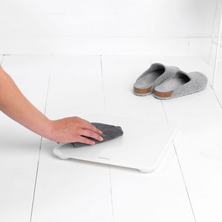 Woman wiping White Digital Bathroom Scales