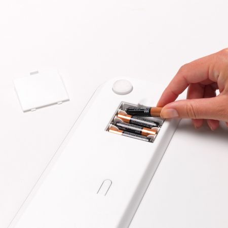 Putting batteries on White Digital Bathroom Scales